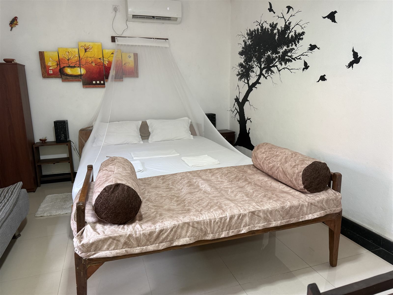 Poolside Comfort Chalet bedroom with daybed and mosquito net at Valampuri Resort